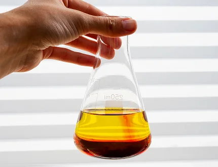 Hand holding oil sample - Clarification & purification process by Palm Oil Mill Plant Manufacturer in India