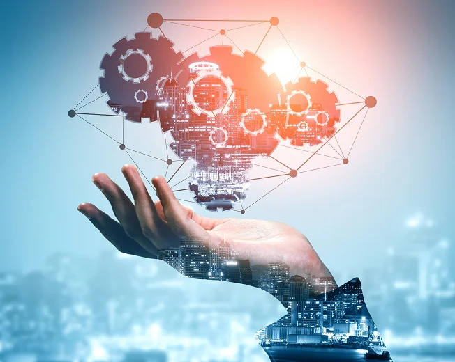  A hand with a cityscape overlay holds glowing interconnected gears and lines, symbolizing innovation and technology integration from a leading Edible Oil Machinery Exporter from India.